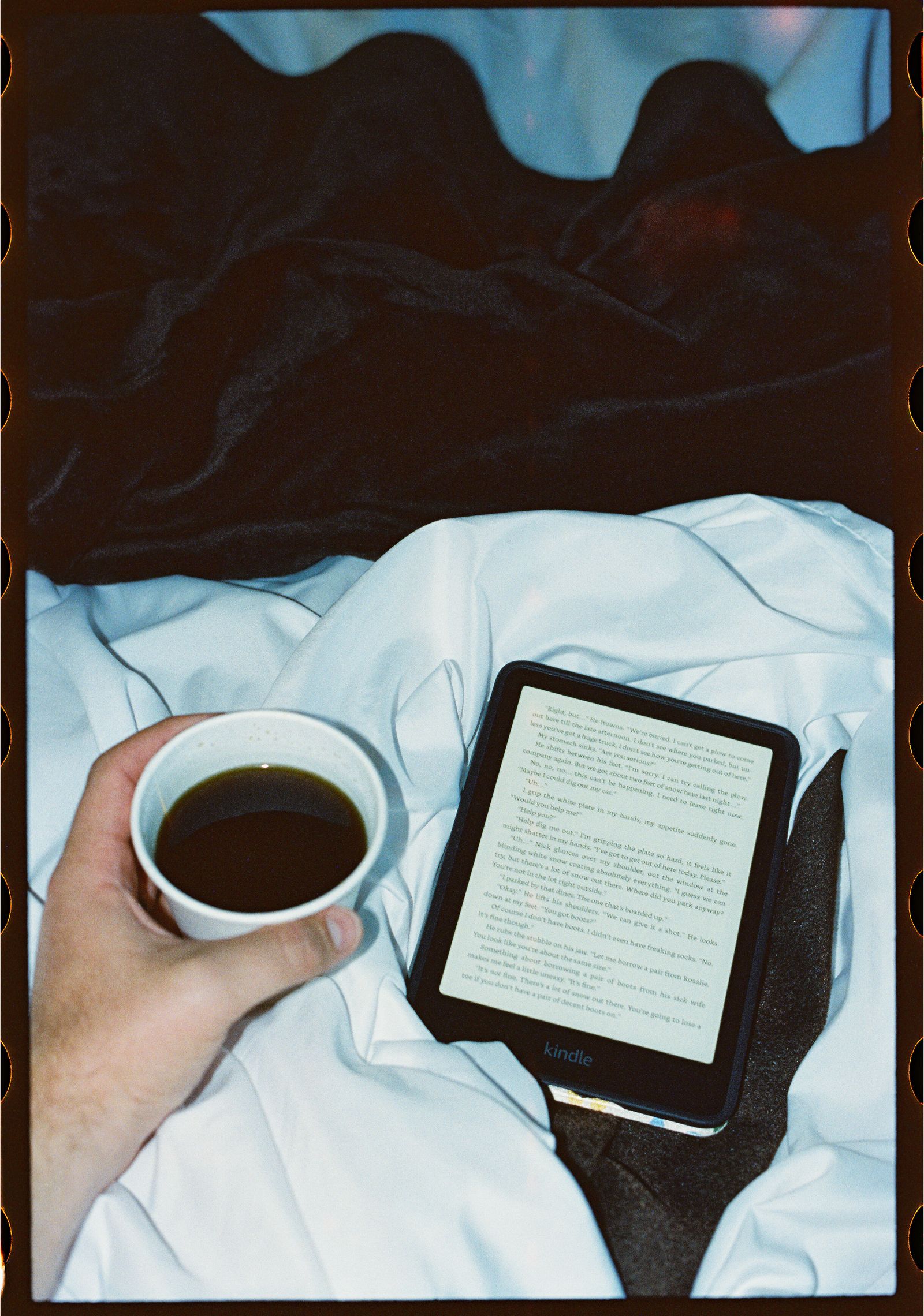 Coffee and a book in bed at Adventure Inn