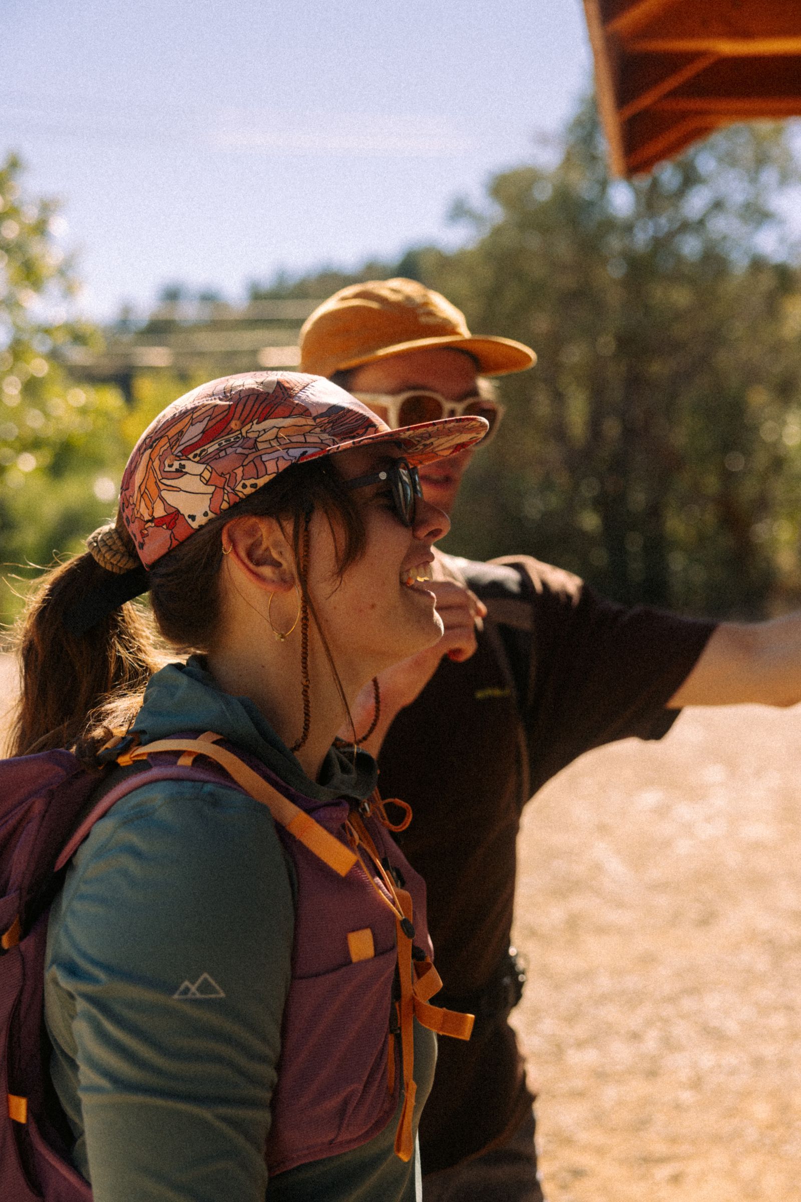 Two friends laughing together on a trail above Durango