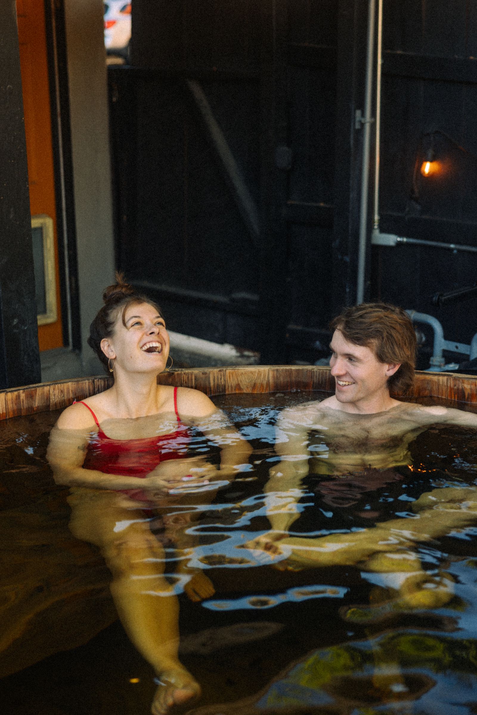 Guests laughing in the cedar hot tub