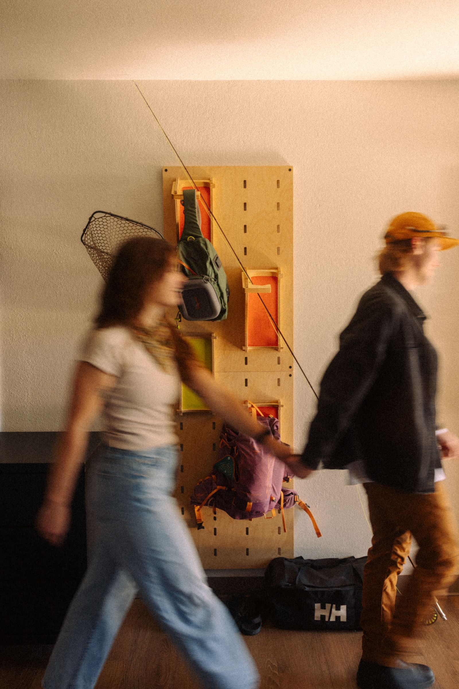 Guests walking past the gear wall in their room