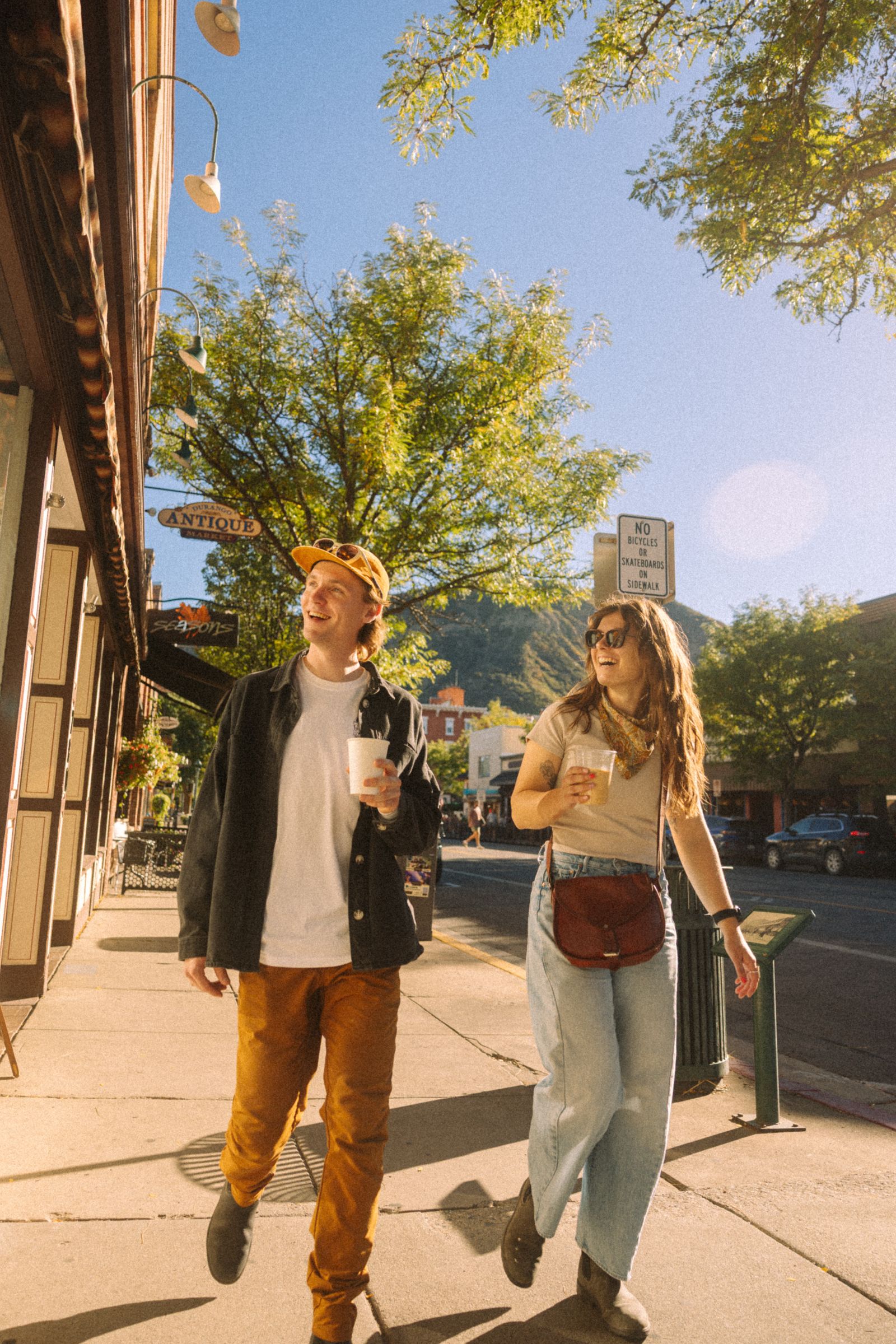 Guests walking Main Avenue in downtown Durango with coffee